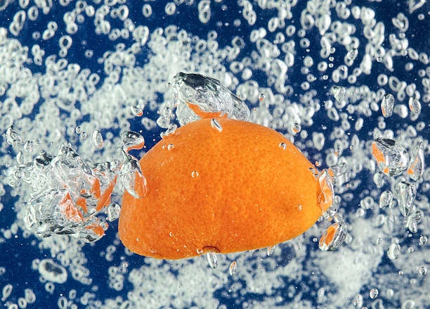 istock Orange (mandarin) floating in water with air bubbles 97468867