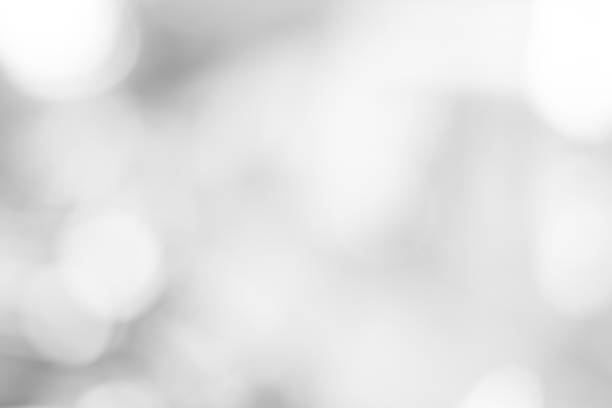 istock white blurred backdrop of nature, circle white wallpaper, gray bokeh background 974691046