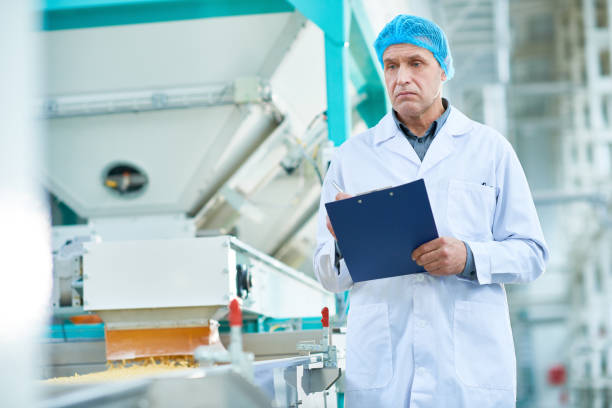 istock Senior Man Sanding at Macaroni Line 974695250
