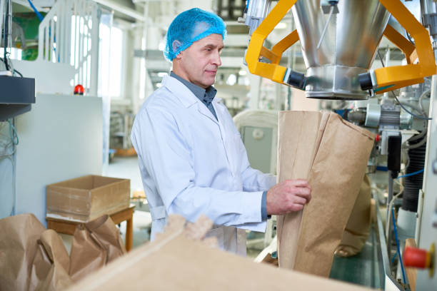 istock Senior Factory Worker Working at Packaging Line 974695290