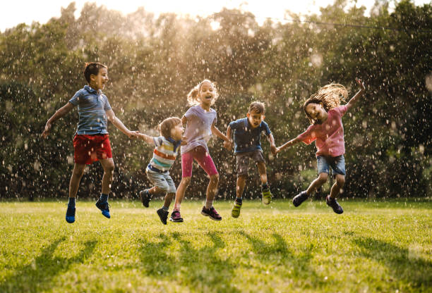 Happy kids on the rain stock photo