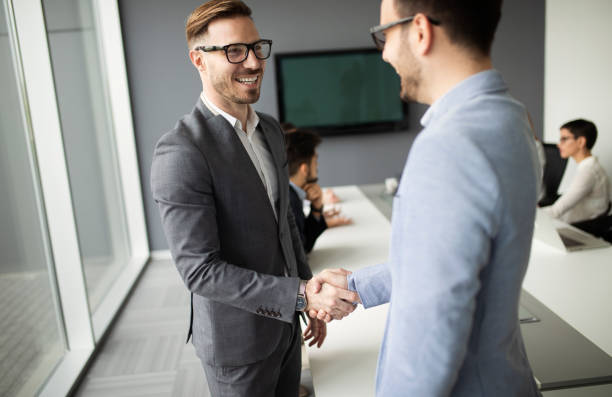 istock Two confident business man shaking hands during a meeting in the office 974697616