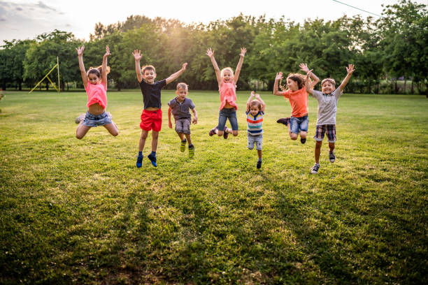 istock Happy kids jumping in nature 974697894