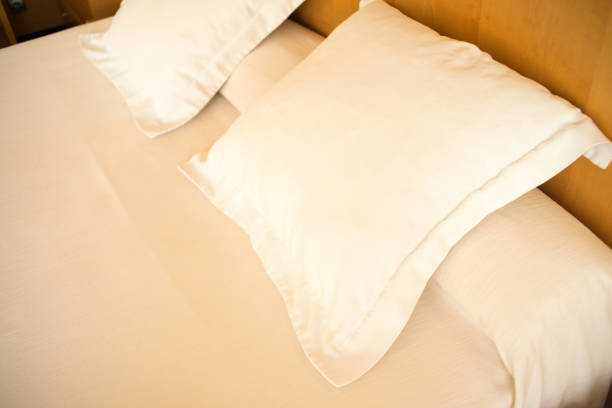 istock Luxury modern style hotel suite bedroom with bed, sheets, pillows clean and ready for guests. 974698142