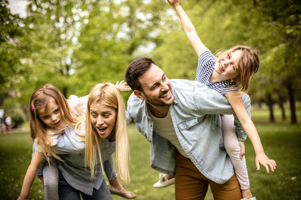 istock Happy parents with daughter at park. 974699086