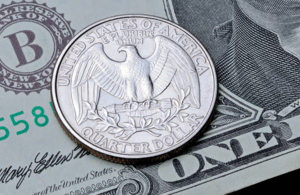 istock US coin quarter dollar on one dollar bill. 974701656