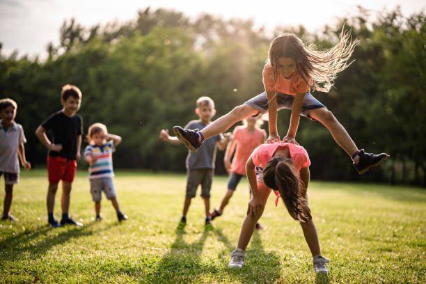 Two child are running in the garden