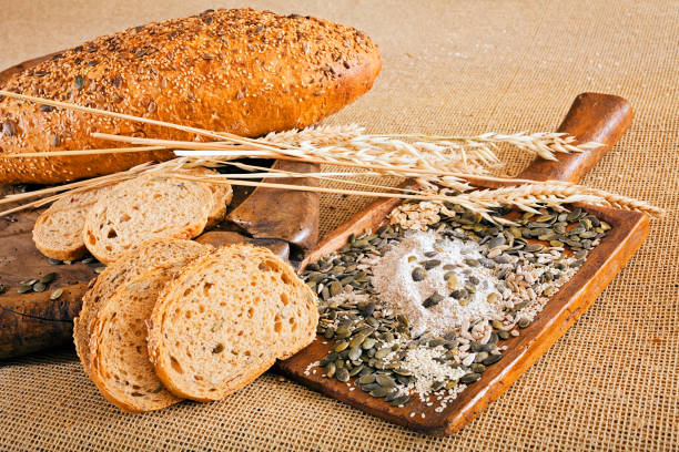 bread with seeds bread with seeds on the wooden plate 30132 stock pictures, royalty-free photos & images