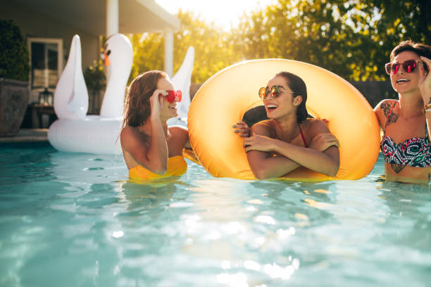 istock Smiling women enjoying in a pool 974704908