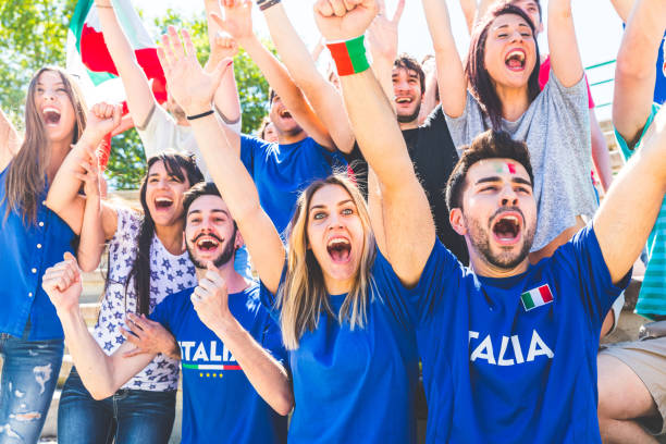 istock Italian supporters celebrating at stadium with flags 974713444