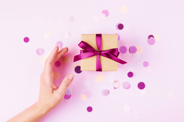 istock Woman hand and gift box. 974716324