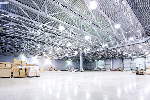 The interior of a new empty lighted warehouse ready to be used