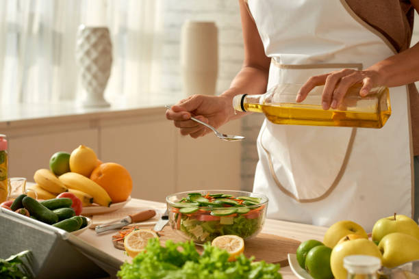 istock Pouring Olive Oil into Salad 974718916