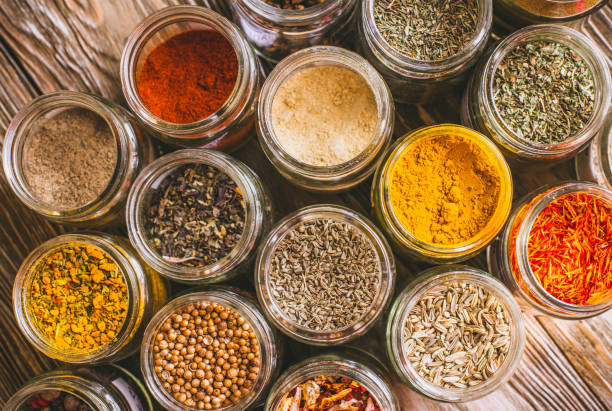 istock Various colorful kinds of spices on rustic wooden table, top view 974718934