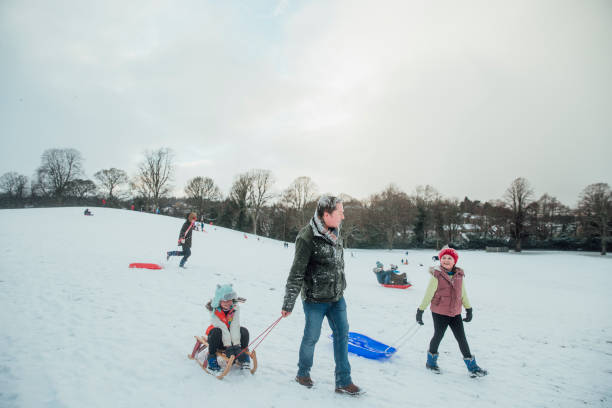 istock Family Sledding in the Snow 974719282