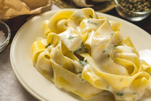 istock Alfredo Pasta Plate with Creamy Cheese and Basil Sauce 974721528