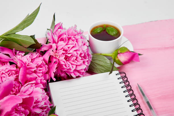 istock Beautiful pink peony flowers with note. 974722078
