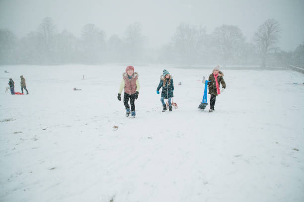 istock Friends Having Fun in the Snow 974722370