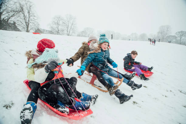 istock Children Having a Sledding Race 974722380