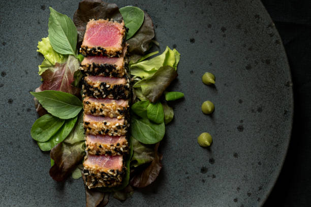 grilled sliced tuna steak in sesame with salad and wasabi sauce - tuna sashimi sea fish imagens e fotografias de stock