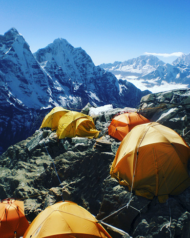 Camping near North Annapurna Base Camp overlooking Annapurna glacier. Outdoor camping scenery with snowy range in Himalayas. Camping outdoor on dramatic mountains background.