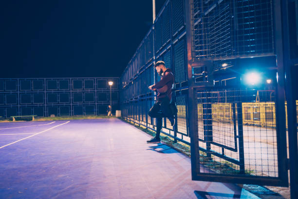 istock Basketball player using mobile phone outdoors 974738580