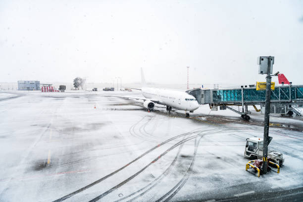 Horizontal color image of airplane during snowstorm.