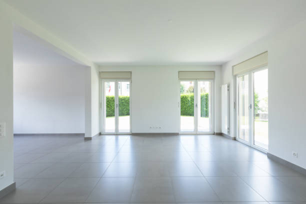 istock Empty room with window and totally white walls 974743934