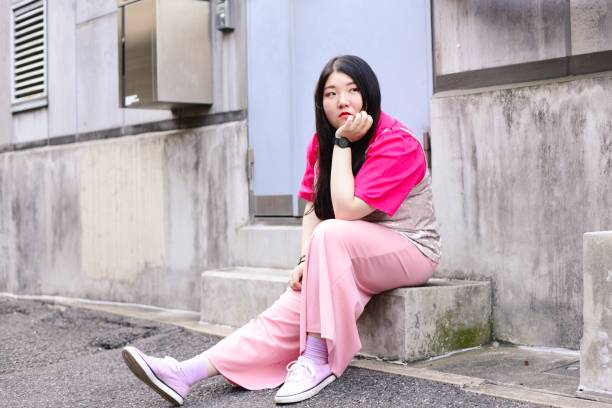 istock Young woman sitting outside, thinking 974749566