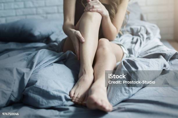 Female Tired Legs In Bed At Home Stock Photo - Download Image Now - Leg, Bed - Furniture, Tired