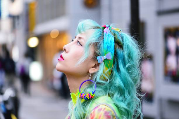 Colourful young woman Portrait of a woman with brightly green/blue hair and colourful clothes. tokyo harajuku stock pictures, royalty-free photos & images