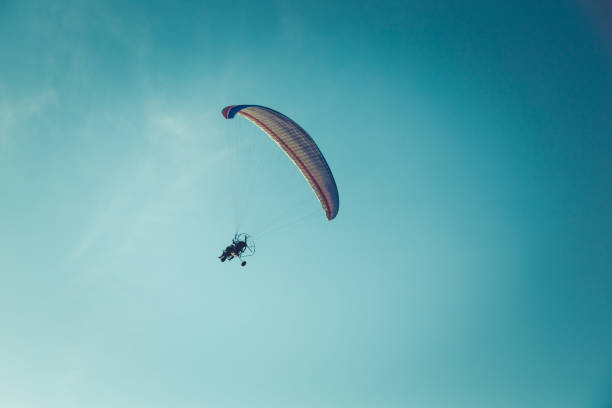 istock Skydiver flying over the water blue sky ocean clouds vacation 974753784