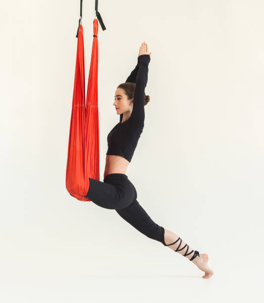 istock Woman practicing fly yoga over white background 974754836