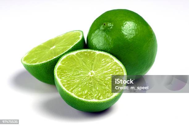 One Whole Lime And Two Lime Halves On A White Background Stock Photo - Download Image Now