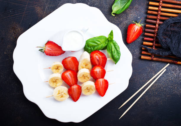 istock banana with strawberry 974757662