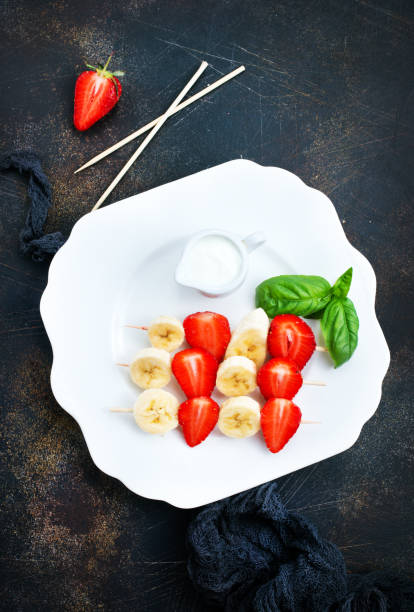 istock banana with strawberry 974757668