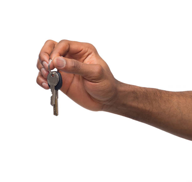 istock Black male hand holding key to your dream 974757956