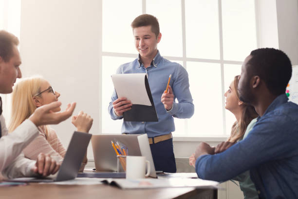 Man giving presentation to colleagues in office