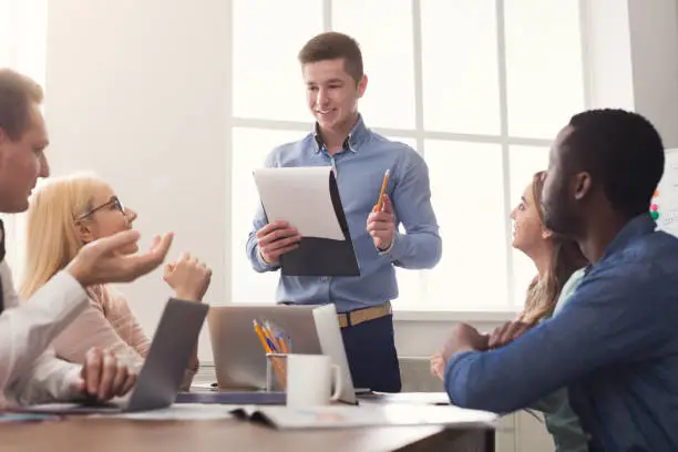 Photo of Man giving presentation to colleagues in office