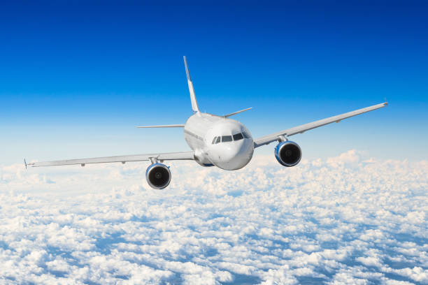 istock Passenger airplane flying at flight level high in the sky above the clouds. 974759344