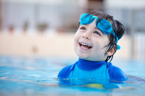istock Happy boy enjoying summer time in swimming pool 974763456