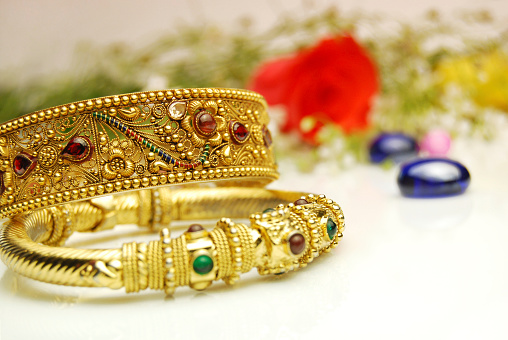 Gold bangles on white background