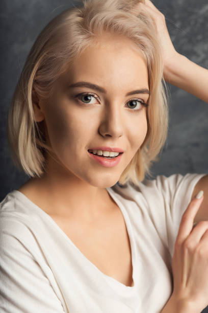 istock Young woman studio headshot portrait on dark background 974777320