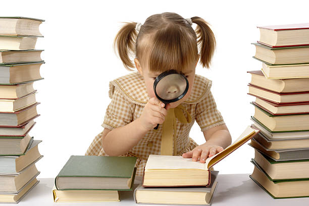 istock Little girl looking at book through magnifier 97478087