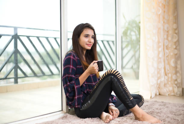 How to occupy yourself during self isolation in a global viral outbreak / pandemic. A professional model / beautiful Russian indoor girl shows several ways to lift the mood while stuck indoors. Here she is exercising in an indoor gym.