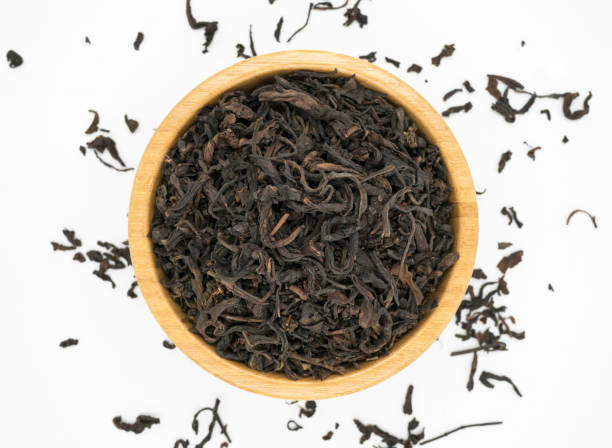 istock Black tea leaves in bowl 974789594