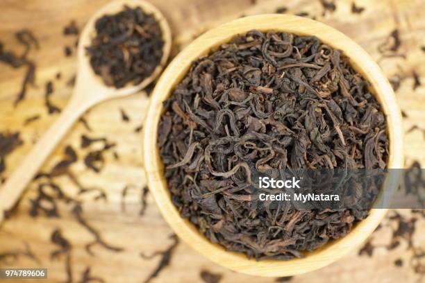 Tea Leaves On Wood Background Stock Photo - Download Image Now - Aromatherapy, Arrangement, Black Tea