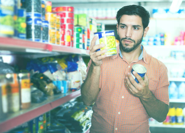 istock Man is choosing canned peas 974790278