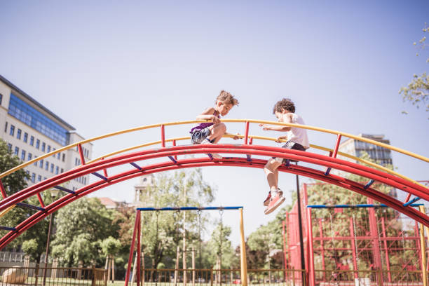 istock Cute mixed race children playing outdoors in public park 974793402