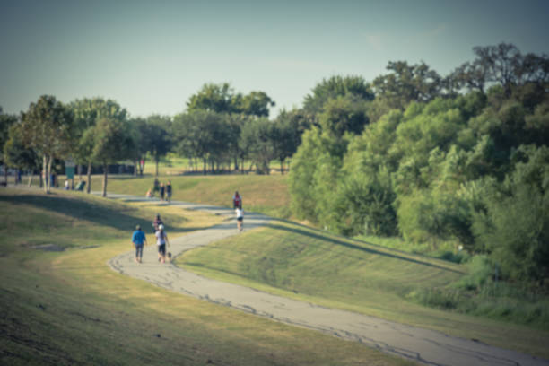 istock Abstract blurred energetic people jog, walk, run, bike through s-curve path 974793852